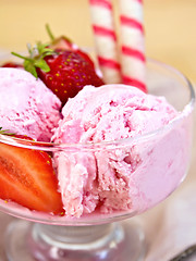 Image showing Ice cream strawberry in glass bowl with waffles on board