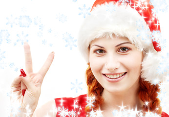 Image showing santa helper showing victory sign with snowflakes