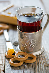 Image showing Glass of tea in an old cup holder.