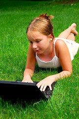 Image showing Girl computer grass