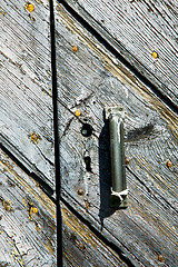 Image showing  cross lombardy    seprio a    rusty brass  door curch  closed i