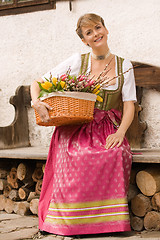 Image showing Young girl with Easter bouquet Bavarian