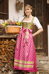 Image showing Young girl with Easter bouquet Bavarian