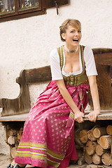 Image showing Bavarian girl in traditional dress at a bank