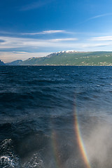 Image showing rainbow on a lake Garda with mountains as background