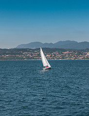 Image showing Sail boat on a lake with mountains as background