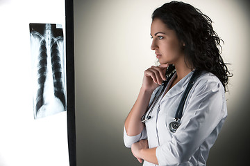 Image showing Image of attractive woman doctor looking at x-ray results