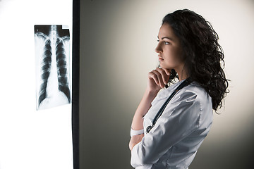 Image showing Image of attractive woman doctor looking at x-ray results