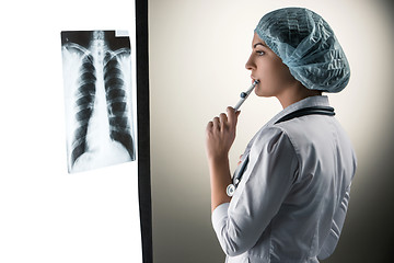 Image showing Image of attractive woman doctor looking at x-ray results