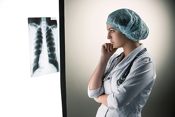 Image showing Image of attractive woman doctor looking at x-ray results