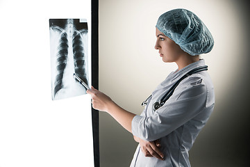 Image showing Image of attractive woman doctor looking at x-ray results