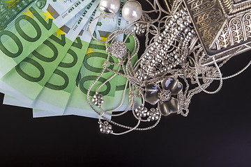 Image showing Silver jewelry and euro