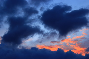 Image showing sunset with dark blue and crimson clouds