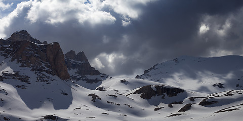 Image showing Panoramic view on snowy mountains in storm clouds