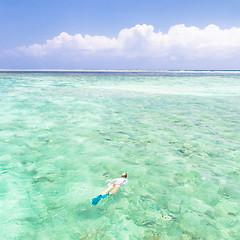 Image showing woman snorkeling in turquoise blue sea.
