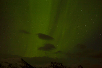 Image showing Northern lights with snowy mountains in the foreground