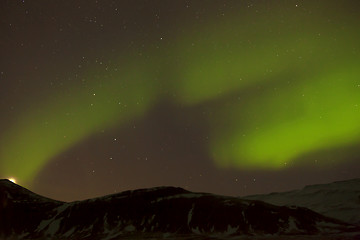 Image showing Northern lights with snowy mountains in the foreground