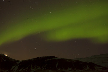 Image showing Northern lights with snowy mountains in the foreground