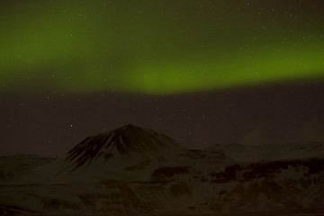 Image showing Northern lights with snowy mountains in the foreground