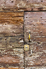 Image showing castellanza   knocker in a  door curch  closed    cross