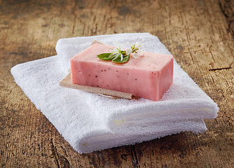 Image showing bar of natural strawberry soap and spa towels
