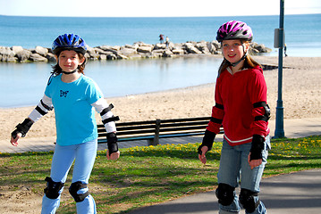 Image showing Girls rollerblade