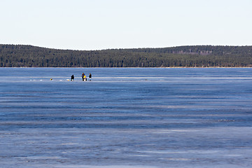 Image showing Fishermen on the ice fishing on the frozen lake