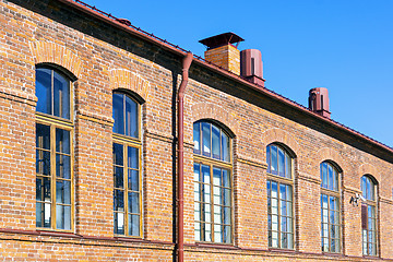 Image showing Retro red brick house wall with windows