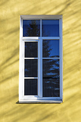 Image showing Old window on yellow wall