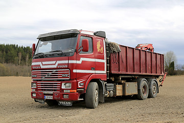 Image showing Early Red Volvo FH12 Truck Parked on a Field