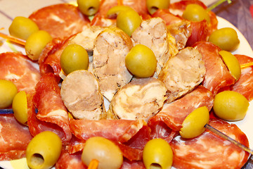 Image showing meat cutting into pieces and olives