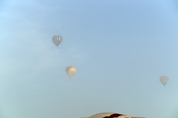 Image showing three hot air balloons in the fog