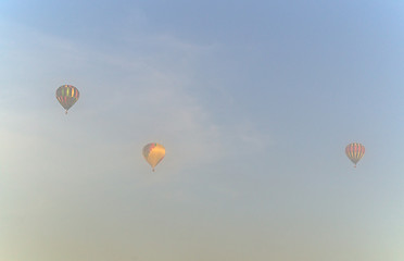 Image showing three hot air balloons in the morning mist