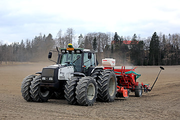 Image showing Valmet 8550 Tractor and Seeder on Field at Spring