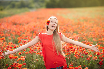 Image showing Happy woman on poppy flower field