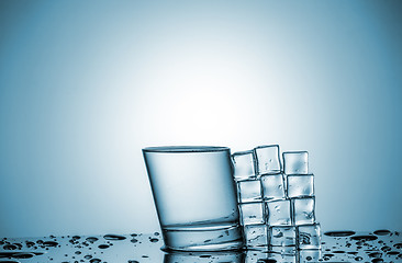 Image showing Water in glass and ice cubes, lying next