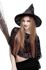 Image showing Girl in witch costume with a broom 