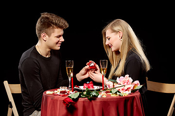 Image showing Man proposing marriage to a surprised woman