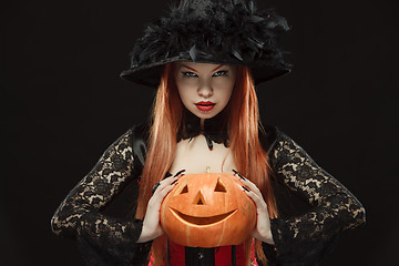 Image showing Girl with Halloween pumpkin on black background