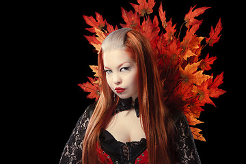 Image showing Young woman with autumn maple leaves 