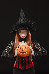 Image showing Girl with Halloween pumpkin on black background