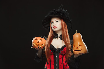 Image showing Girl with two Halloween pumpkin on black background