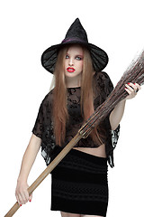 Image showing Young girl in witch costume with a broom