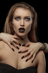 Image showing Pretty gothic  brunette woman with hands on neck