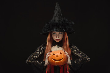 Image showing Girl with Halloween pumpkin on black background