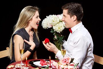 Image showing Man proposing marriage to a surprised woman