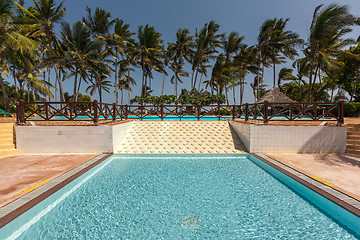 Image showing Swimming pool, palm trees and blue sky