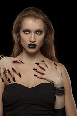 Image showing Gothic woman with hands of vampire on her body. Halloween