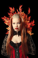 Image showing Young woman with autumn maple leaves 
