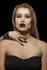 Image showing Gothic woman with hand of vampire on her neck. Halloween